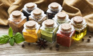 Jars with dried herbs, spices on the table